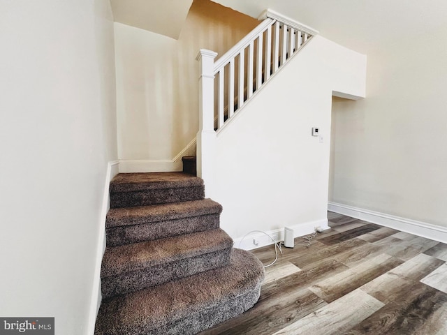 stairway featuring hardwood / wood-style flooring