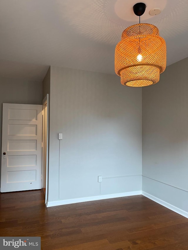 unfurnished room featuring dark wood-type flooring