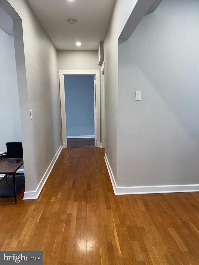 corridor featuring hardwood / wood-style floors