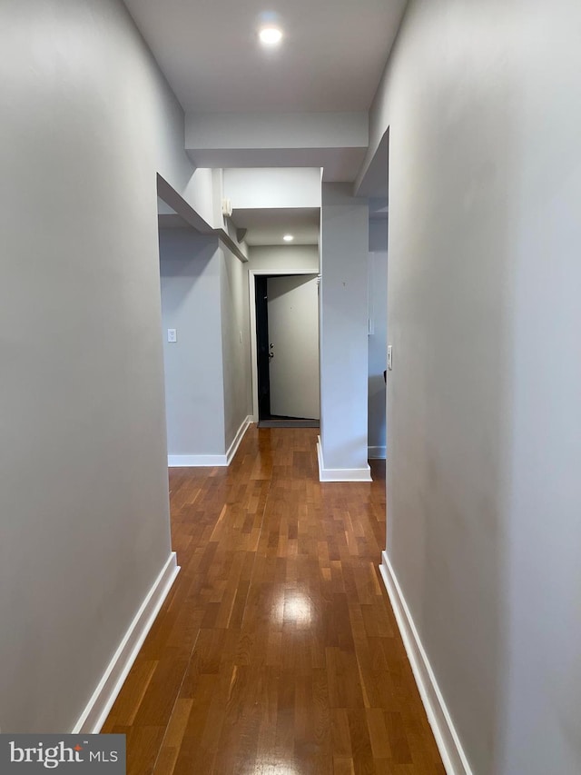 hall with dark wood-type flooring