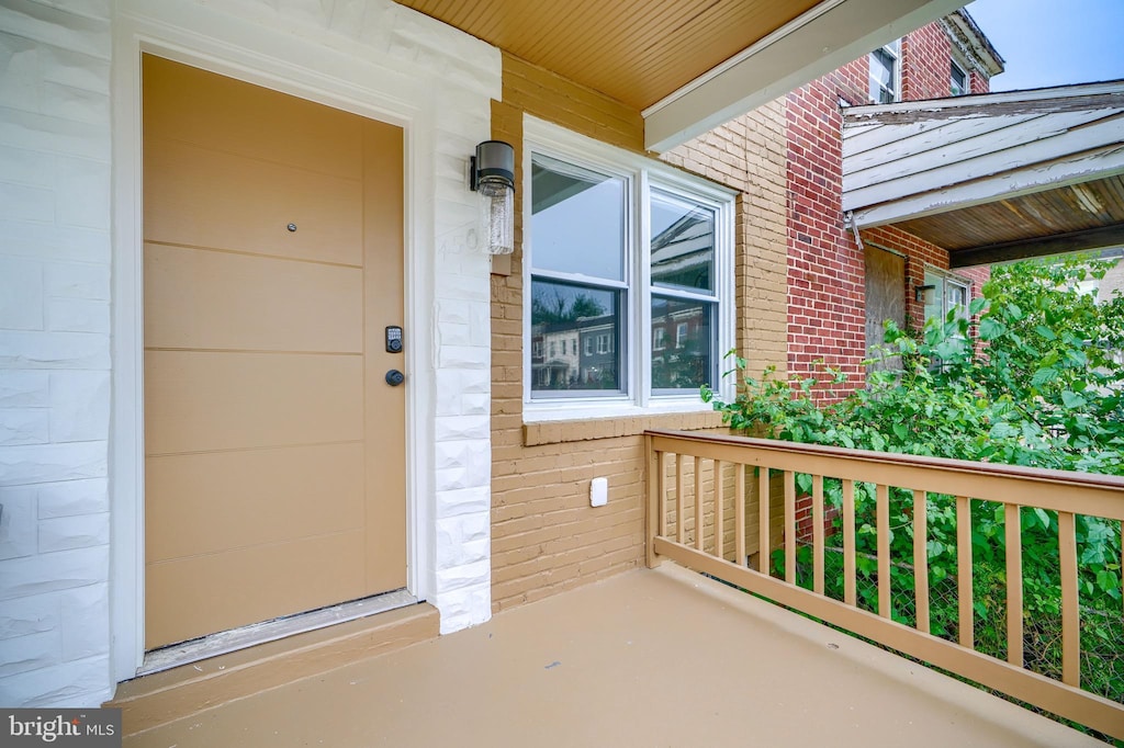 view of exterior entry with a porch