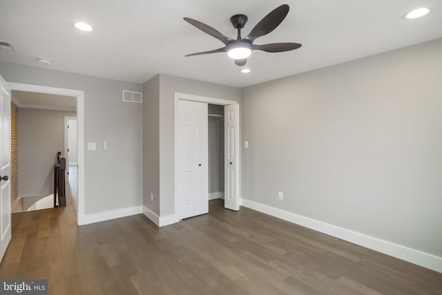 unfurnished bedroom featuring ceiling fan and dark hardwood / wood-style floors