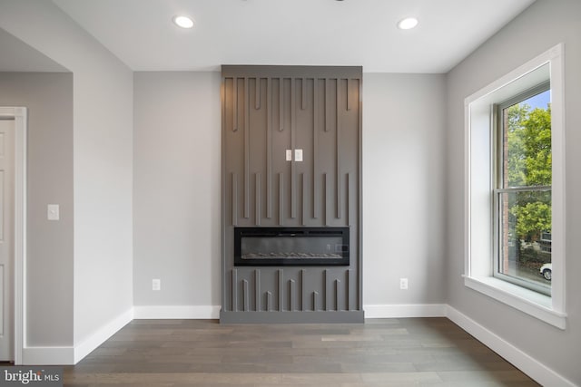 unfurnished living room with plenty of natural light and hardwood / wood-style floors