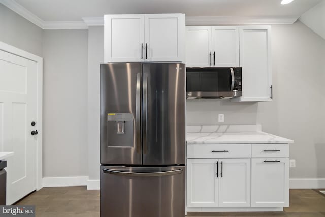 kitchen featuring light stone countertops, white cabinetry, dark hardwood / wood-style floors, and stainless steel appliances