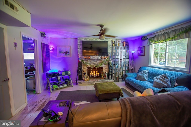 living room with light hardwood / wood-style floors and a brick fireplace