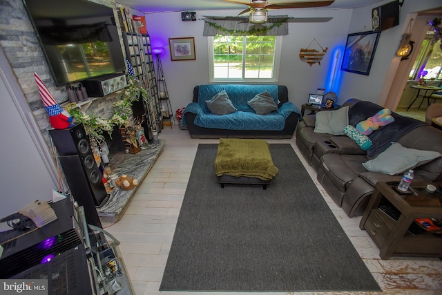 living room with light hardwood / wood-style flooring and ceiling fan