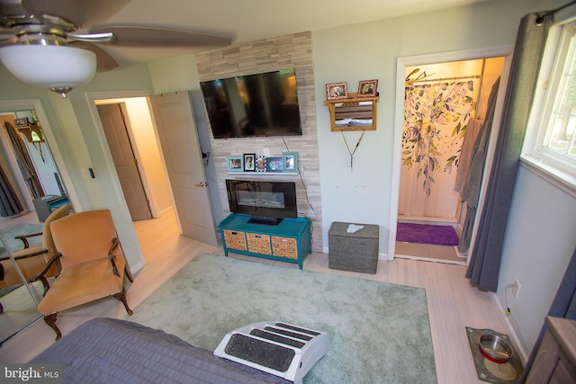 living room featuring light hardwood / wood-style flooring and ceiling fan