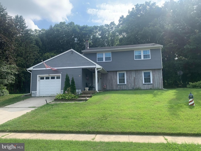 front of property featuring a garage and a front yard