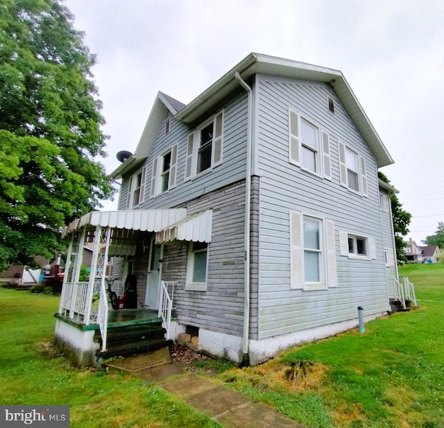 view of side of home featuring a yard