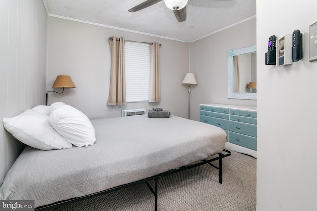 carpeted bedroom with ornamental molding, ceiling fan, and a textured ceiling