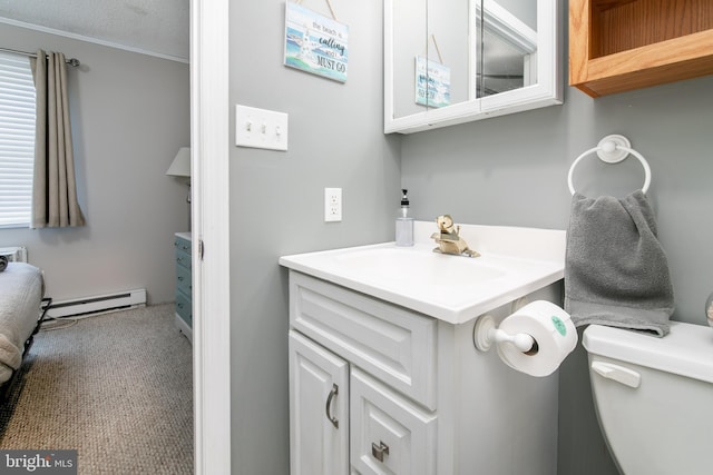 half bathroom with toilet, a baseboard radiator, and vanity