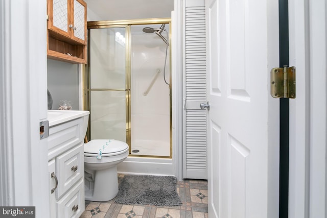 full bath featuring toilet, a closet, a shower stall, and vanity