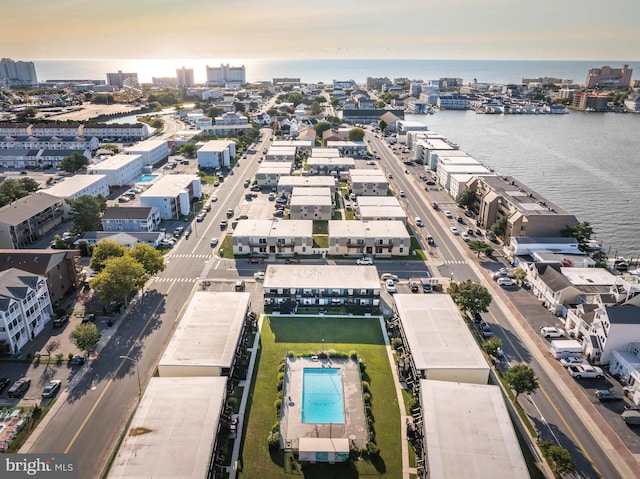 aerial view at dusk with a view of city and a water view