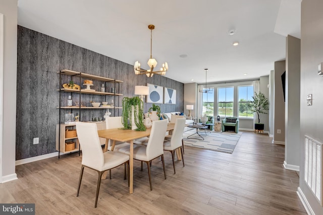 dining area featuring an inviting chandelier and wood-type flooring