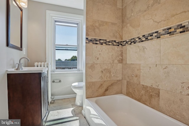 bathroom with vanity, toilet, a tub, and tile patterned flooring