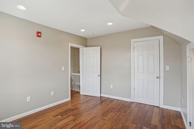 unfurnished bedroom featuring dark hardwood / wood-style floors