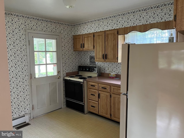 kitchen featuring white refrigerator, a baseboard radiator, and range with electric stovetop