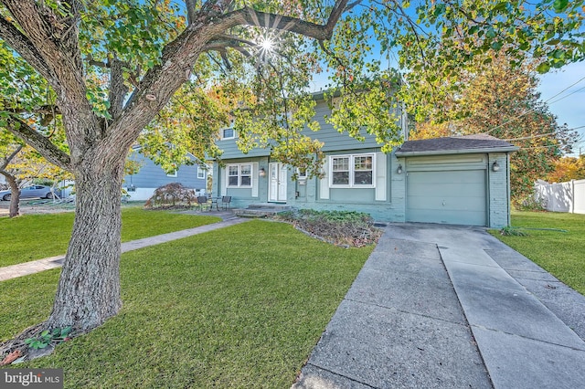 view of front facade with a front yard and a garage