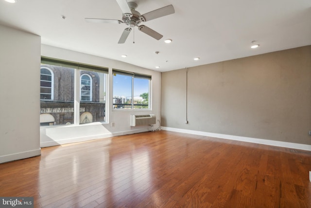 unfurnished living room with light hardwood / wood-style floors, ceiling fan, and a wall mounted air conditioner