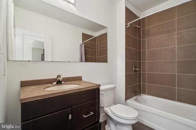 full bathroom with toilet, tiled shower / bath combo, and vanity