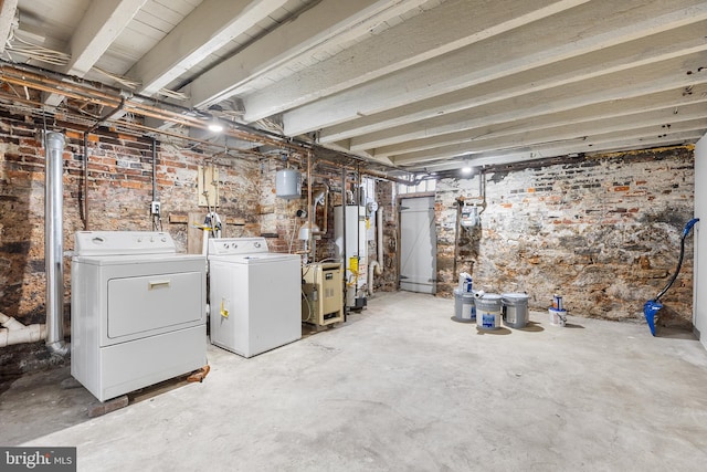 basement with washing machine and clothes dryer and gas water heater