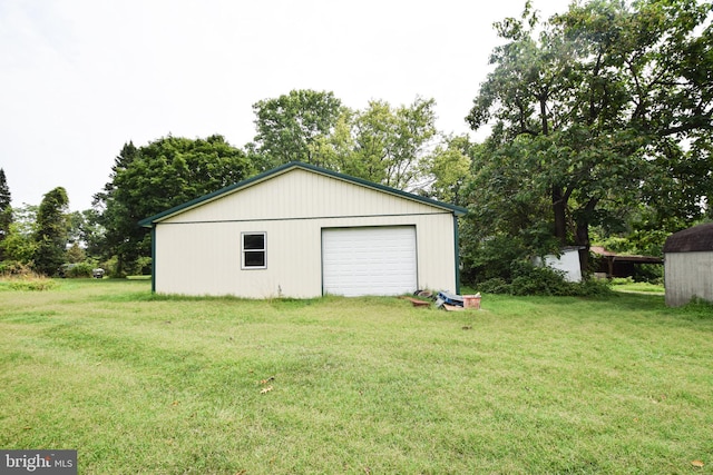 garage featuring a lawn