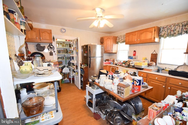 kitchen with stainless steel refrigerator, ceiling fan, light hardwood / wood-style floors, and a wealth of natural light