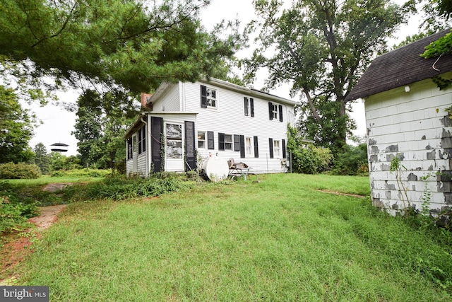 back of house featuring a yard