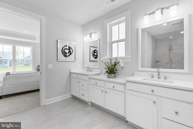 bathroom with vanity, tile patterned flooring, a tile shower, and crown molding