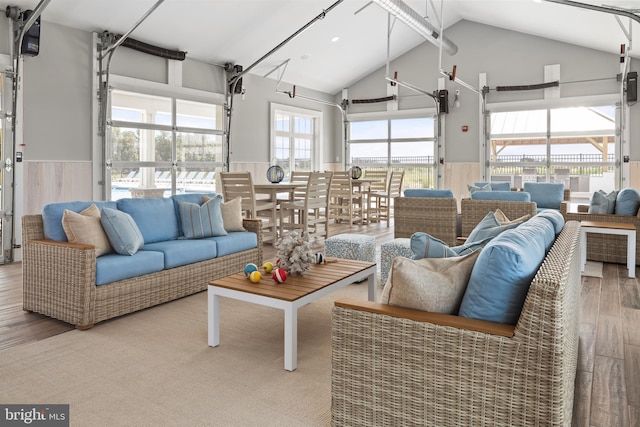 interior space with high vaulted ceiling and hardwood / wood-style floors