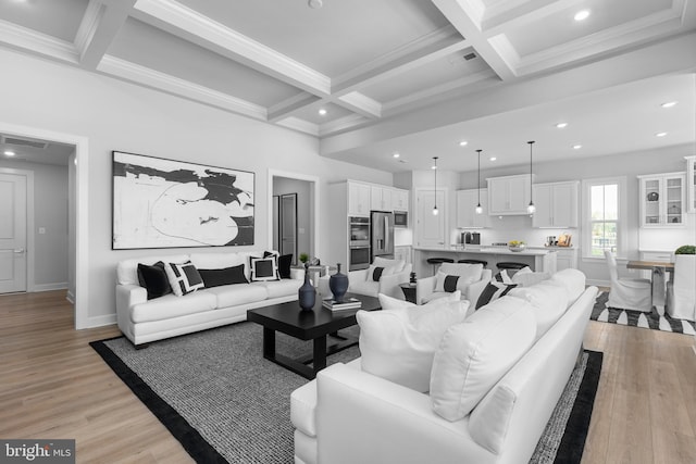 living room with light wood-type flooring, coffered ceiling, and beamed ceiling