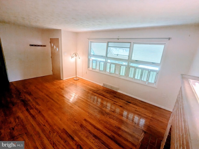 spare room featuring wood-type flooring