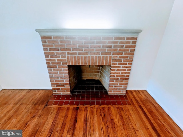 room details featuring hardwood / wood-style flooring and a fireplace