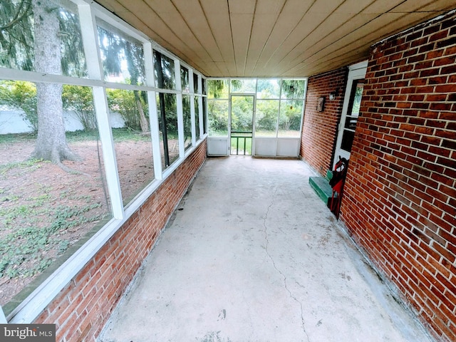 unfurnished sunroom featuring wooden ceiling