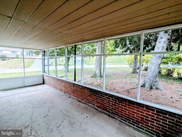 unfurnished sunroom featuring wood ceiling