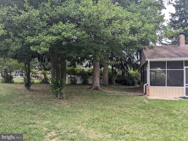 view of yard with a sunroom