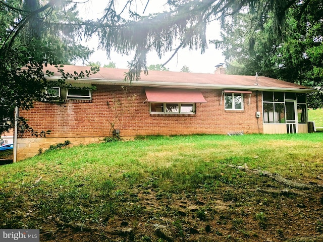 rear view of property with a sunroom