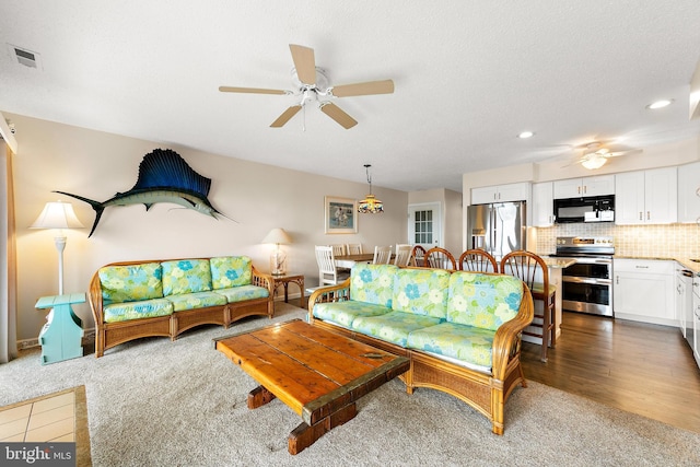 carpeted living room featuring ceiling fan