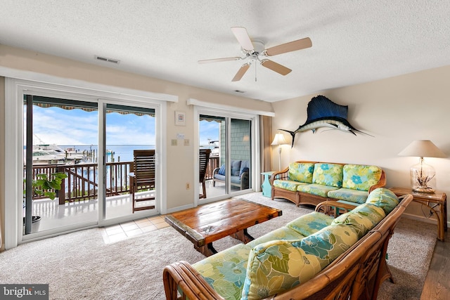 living room with a healthy amount of sunlight and light colored carpet