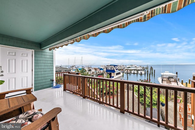 balcony featuring a dock and a water view