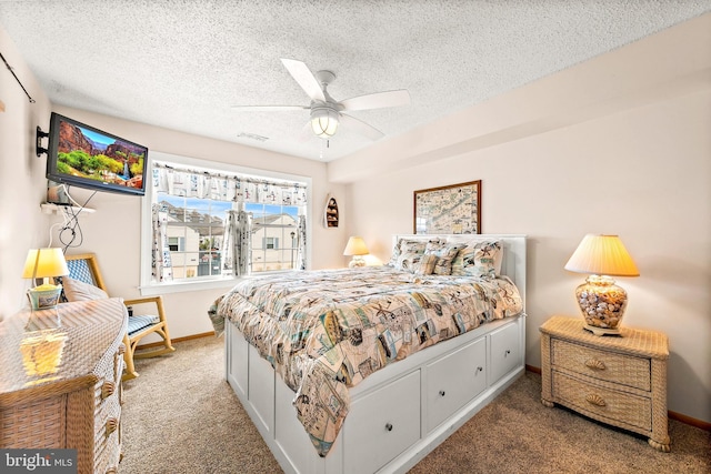 bedroom featuring carpet floors, a textured ceiling, and ceiling fan