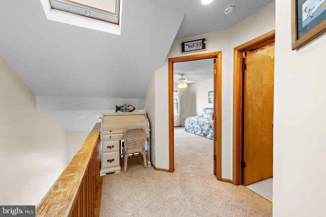 carpeted office featuring lofted ceiling and ceiling fan