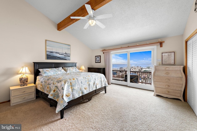 carpeted bedroom with lofted ceiling with beams, access to exterior, a water view, a textured ceiling, and ceiling fan