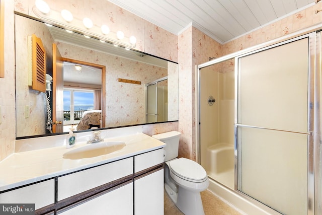 bathroom with a shower with shower door, toilet, and vanity