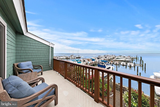 balcony featuring a dock and a water view