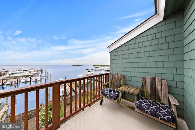 balcony featuring a water view and a boat dock