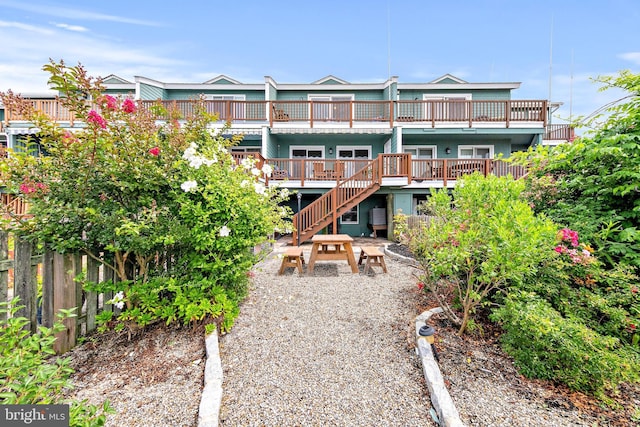 back of house featuring a wooden deck