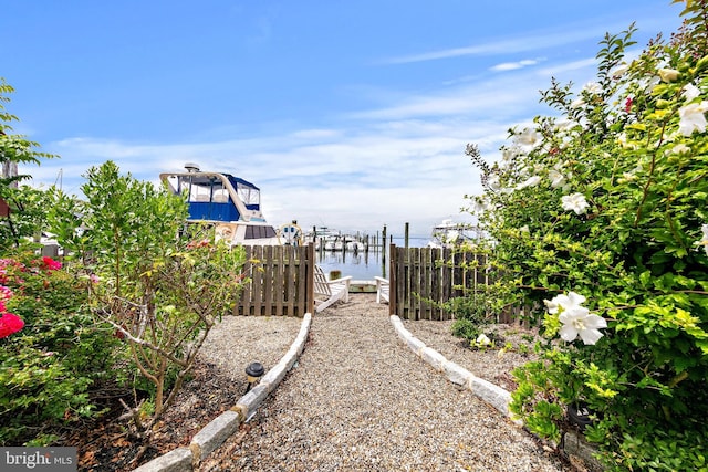 view of yard featuring a dock and a water view