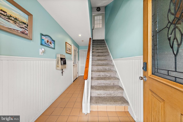 stairs featuring light tile patterned floors