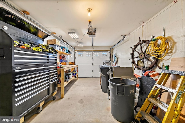 garage with a garage door opener and a workshop area